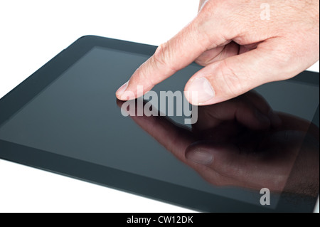A man uses a touchpad tablet to gain wireless Internet access. Stock Photo