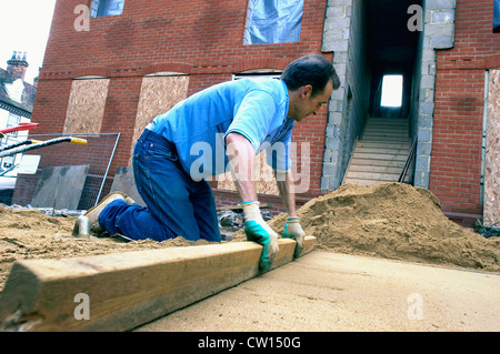 Laying sand for the foundation of a driveway. England, UK. Stock Photo