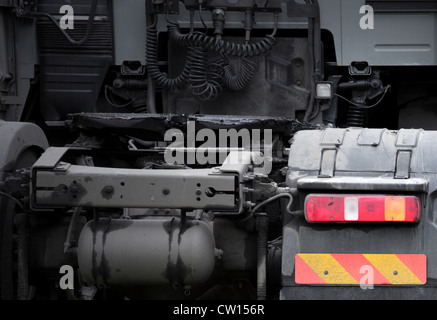 Rear view fragment of truck tractor with bright taillight and striped sign Stock Photo