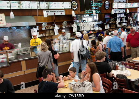 Diners fill tables and wait at the counter inside the historic Katz's Delicatessen restaurant in the Lower East Side of Manhattan, New York City. Stock Photo