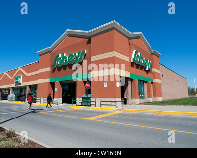 An exterior view of customers walking into the entrance of Sobeys  supermarket open 24 hours and sign in Ontario Canada Stock Photo