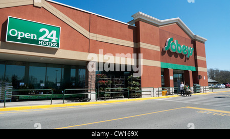 Sobeys supermarket Open 24 Hours sign and young men at the entrance ...