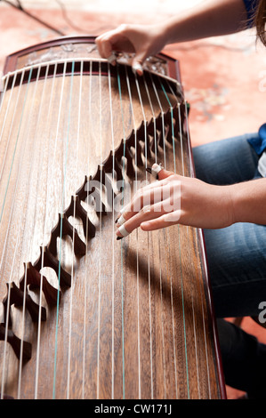 Musician playing traditional Chinese Guzheng Stock Photo