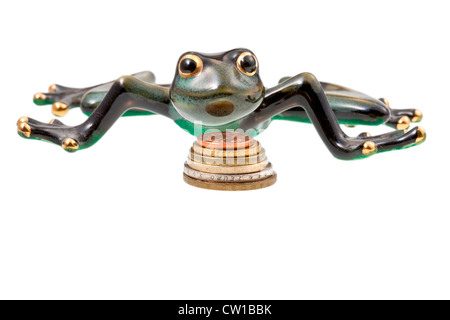 ceramic frog and coins isolated on white Stock Photo