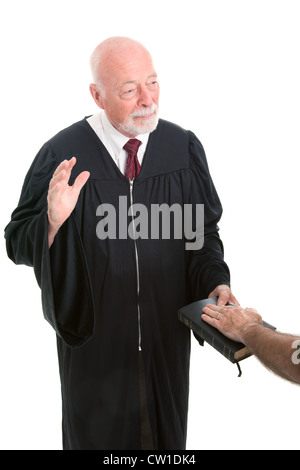 Judge swearing in a witness on the Holy Bible. Isolated on white.  Stock Photo