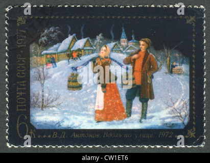 USSR - CIRCA 1977: Postage stamps printed in the USSR, shows a painting by V.D.Antonov, 'Along the street', circa 1977 Stock Photo