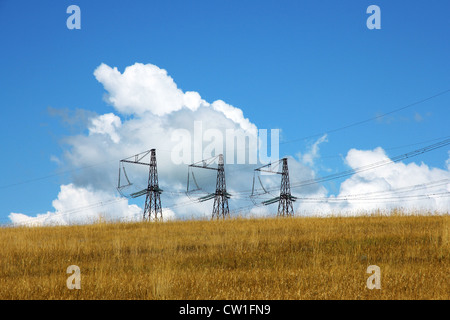 Three electrical towers background of clouds and sky Stock Photo