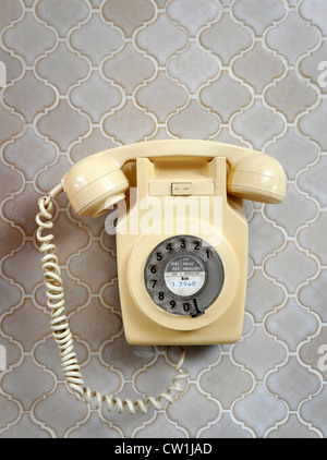 A classic wall mounted bakelite telephone in a 1970's style house which was featured in a 1975 magazine makeover UK Stock Photo