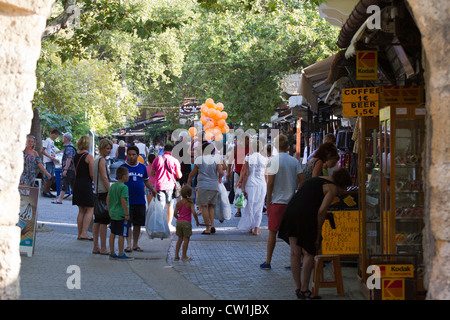 A busy street in old town Rhodes with a backdrop of Rhodes Turkish heritage, Greece, Mediterranean Stock Photo