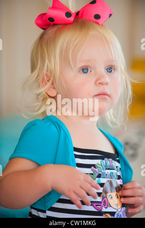 Young blond toddler girl, 2 years old caucasian, with pink bow in her hair Stock Photo