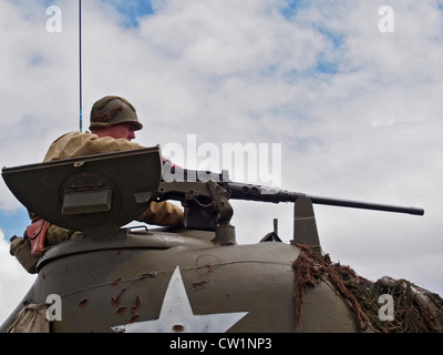 Close up of tank commander aiming machine gun on American Sherman Tank at Military Vehicle show in Essex 2012. Stock Photo