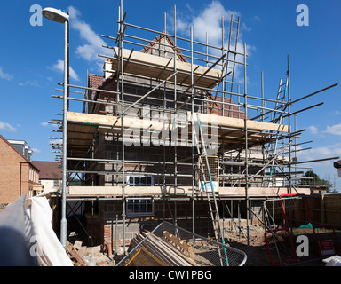 New build house on new estate under construction with scaffolding, Abergavenny, Wales, UK Stock Photo