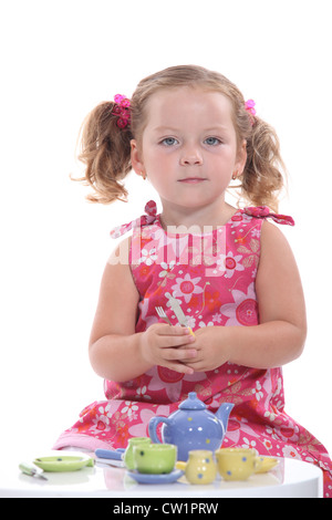 Little girl having tea Stock Photo