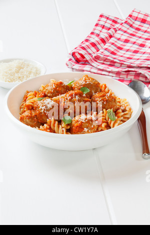 A bowl of meatballs with fusili pasta and tomato sauce, or marinara. Meatballs are made from turkey mince. Stock Photo