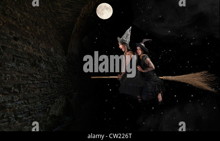 two halloween witches flying on a broom Stock Photo