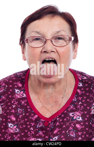 Funny senior woman sticking out tongue, isolated on white background. Stock Photo