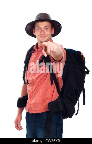 Young man traveling with backpack and pointing at you, isolated on white background. Stock Photo