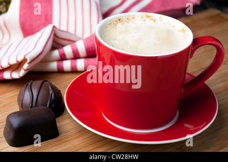 Fresh latte and two chocolate candy for a well deserved break. Stock Photo