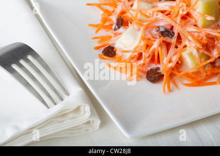 Fresh carrot salad with shredded carrots, raisins, apples and a light curry yogurt dressing. Stock Photo
