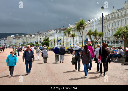 People on the Promenade, on a changeable summer's day, North Shore,  Llandudno, Conwy County Borough, Wales UK. Stock Photo
