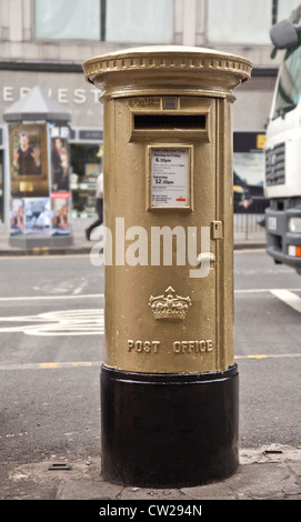 Post Office postbox, central Edinburgh, one of two painted gold to honour Sir Chris Hoy winning two Gold Medals at London 2012 Olympic Games. Stock Photo