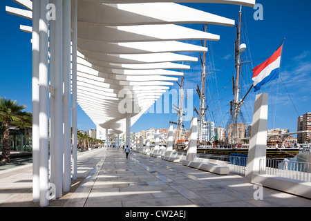 Malaga Spain. Modern harbor boulevard promenade El Palmeral de las Sorpresas with Tall Ship Stad Amsterdam sailing cruise ship. Málaga Stock Photo