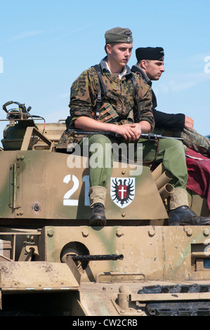WWII World War 2 German Soldiers In Uniform on An Armoured Vehicle at a Military Reenactment Stock Photo