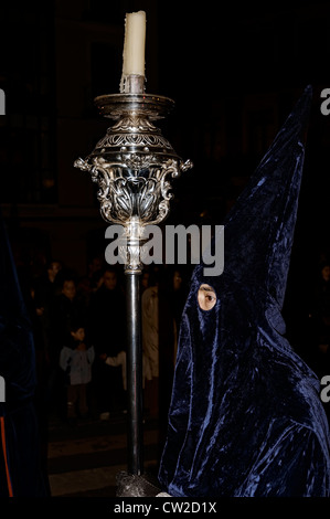 Penitent brother of the brotherhood of las Angustias with a silver lamp in the procession of Holy Week in the city of Valladolid, Spain, Europe. Stock Photo