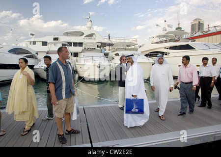Dubai, a group of Arab men in front of luxury yachts marina
