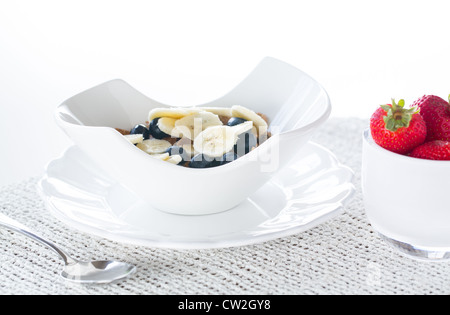 Breakfast of blueberries, bran flakes strawberries with banana Stock Photo