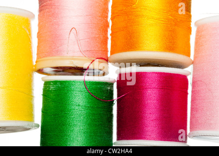 Many colors of cotton thread on bobbins Stock Photo