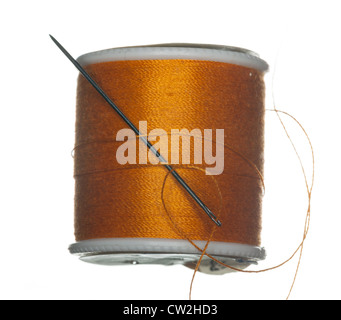 Orange cotton thread on bobbin isolated against white Stock Photo