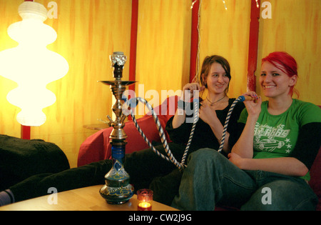 Berlin, two young women smoking hookah Stock Photo