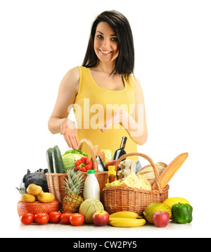 Young woman with grocery in wicker baskets isolated on white Stock Photo