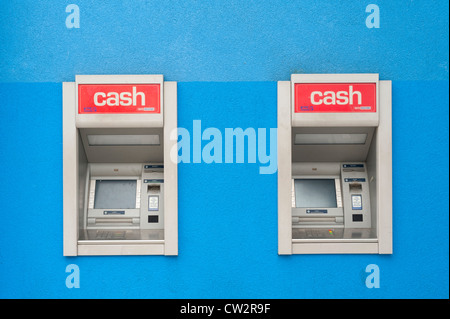 Two cash points on a blue painted wall Stock Photo