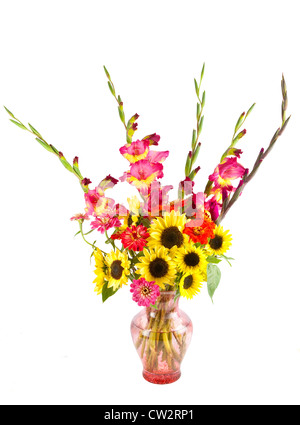 A bunch of home grown summer flowers, including sunflowers, gladiola, zinnia in a glass vase. Stock Photo