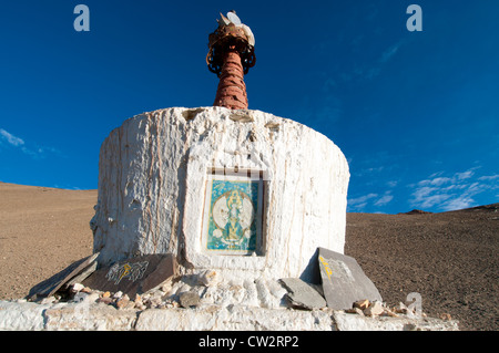 A handmade wall, prayer stones and a chorten with painting on it in the high altitude village of Korzok, Ladakh, India Stock Photo