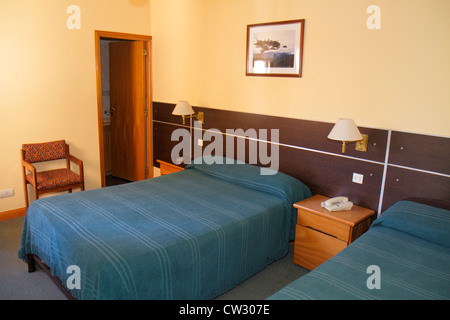 Mendoza Argentina,Avenida San Juan,Hotel Pacifico,lodging,guest room,budget,bed,nightstand,sconce,chair,bedspread,Latin American,South America,Argen12 Stock Photo