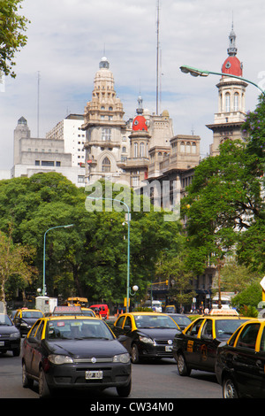 Buenos Aires Argentina,Avenida de Mayo,street scene,tree lined avenue,traffic,one way,taxi,taxis,cab,cabs,car,skyline,building,cupola,architecture bus Stock Photo