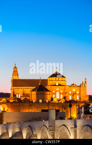 Cordoba Spain Cordoba Cathedral Great Mosque Mezquita Mesquita World Heritage Site Roman Bridge at dusk  Andalusia Andalucia Andalucía Stock Photo