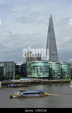 View of The Shard building looking south across the River Thames with the Thames Clipper shuttle boat in the foreground. Stock Photo