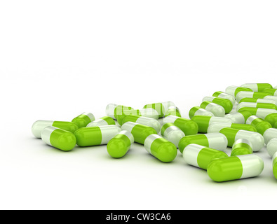 Green pills on white background Stock Photo