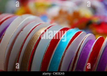 Rolls of ribbons in various colours and patterns reeady to beused to wrap gifts Stock Photo