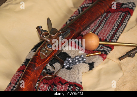 A hand-made flintlock rifle and accessories adorn a rotting stump Stock  Photo - Alamy