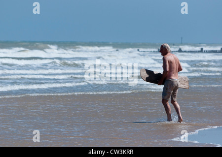 male pensioner body boarding Stock Photo