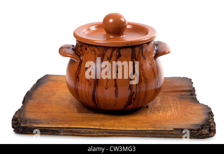 Dirty ceramic pot on old kitchen board. Isolated on white background Stock Photo