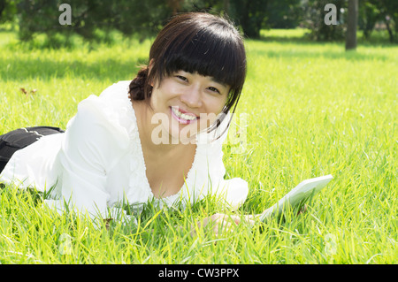 girl using tablet pc on the grass Stock Photo
