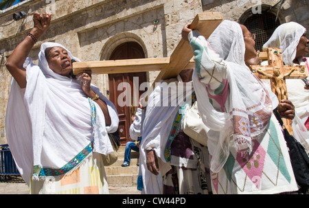 Ethiopian Christian pilgrims carry across along the Via Dolorosa in Jerusalem Stock Photo