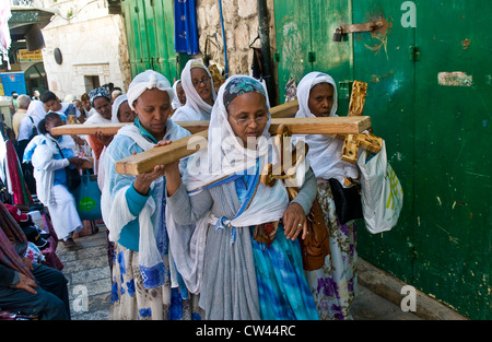 Ethiopian Christian pilgrims carry across along the Via Dolorosa in Jerusalem Stock Photo