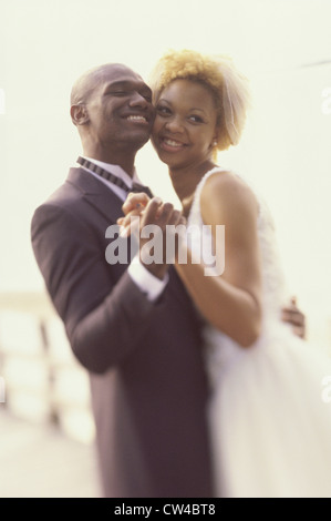 Side profile of a newlywed couple dancing Stock Photo
